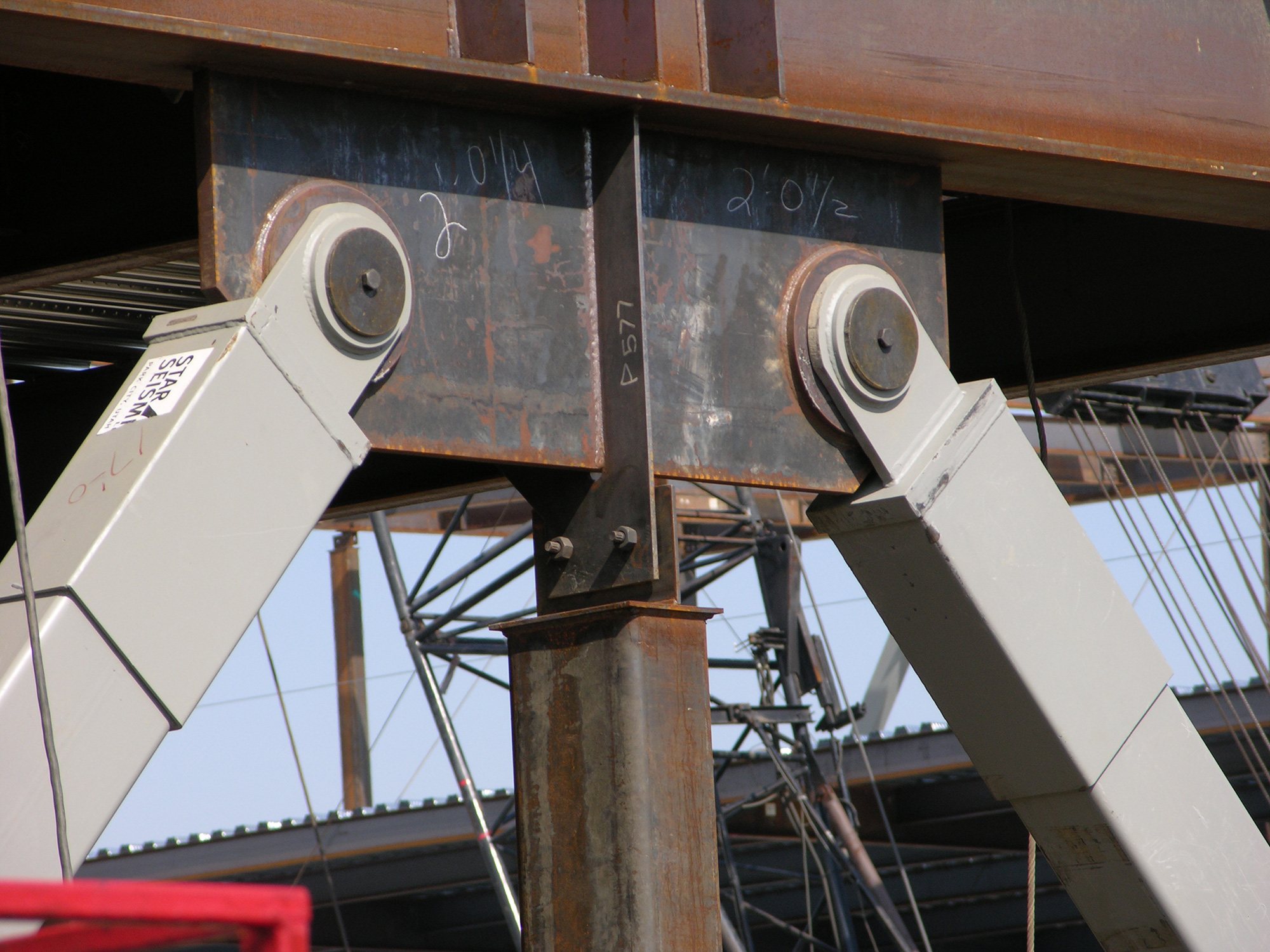 Two light brown stilts reinforce a structure on a Coffman earthquake engineering project site.