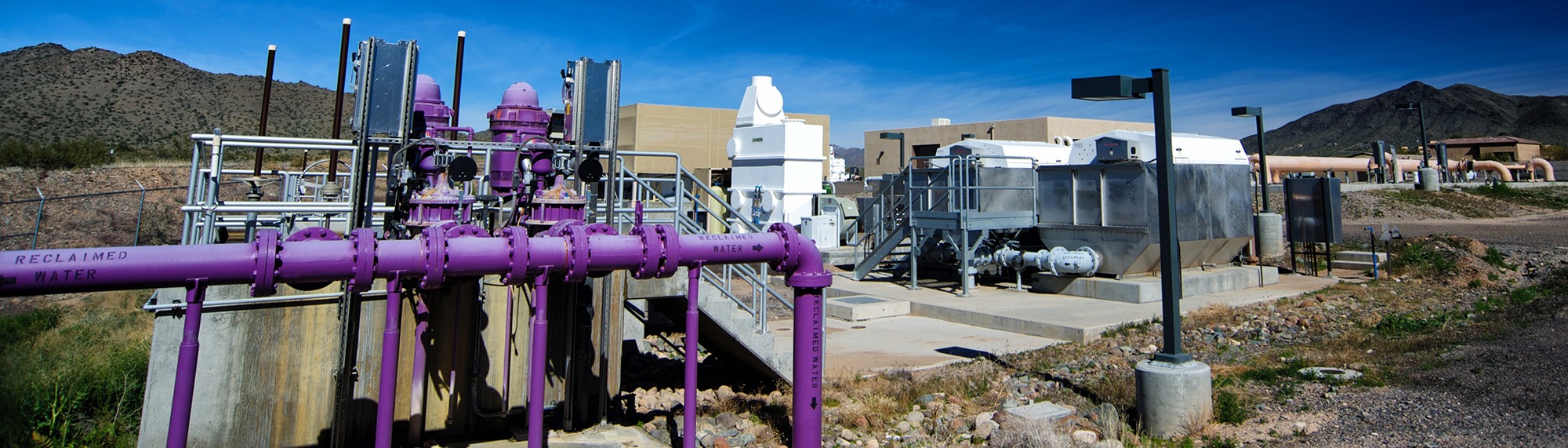 Purple pipes run through a sunny, desert Coffman Engineers job site.