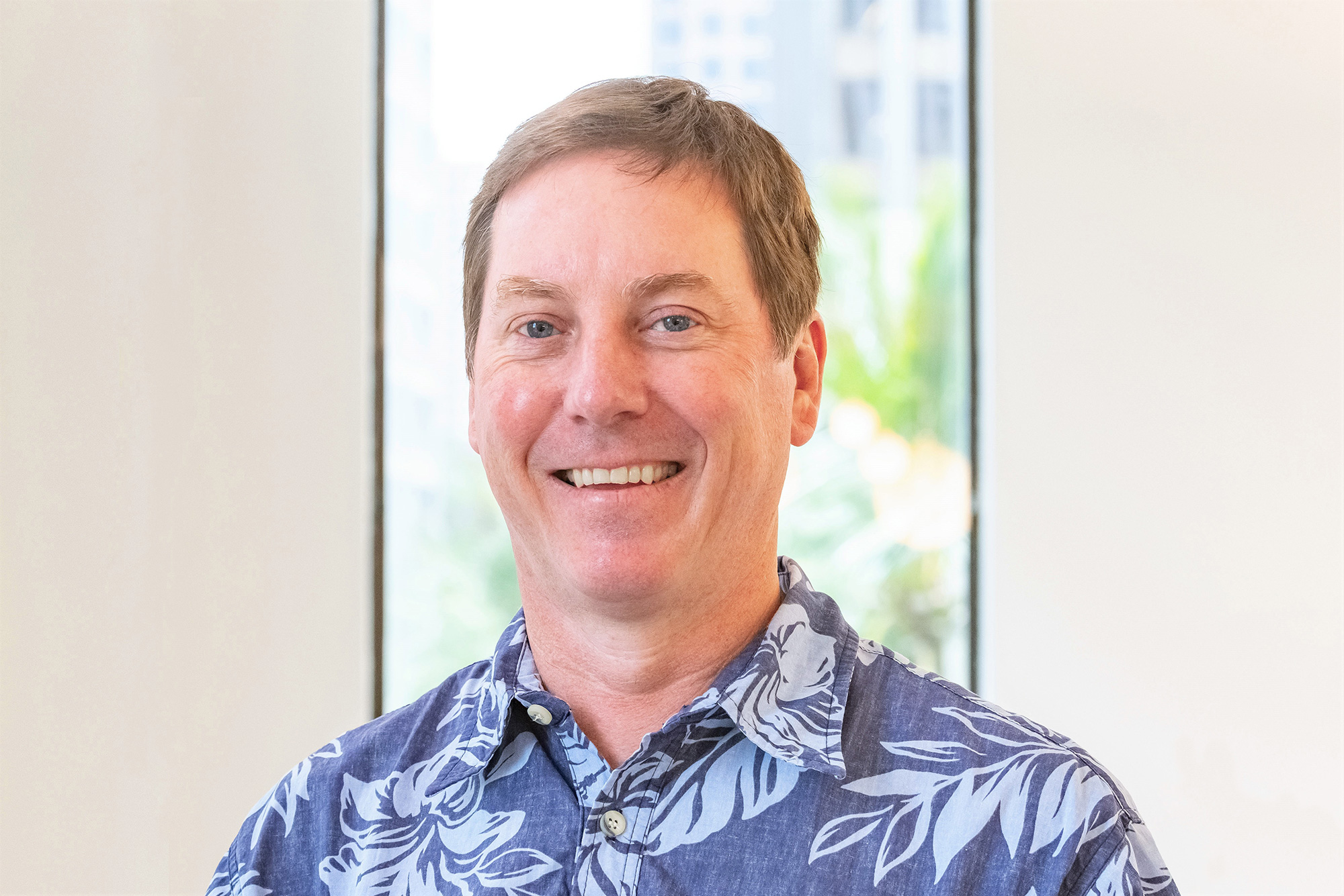Principal mechanical engineer Nick Allday wearing a blue flower patterned button-down.