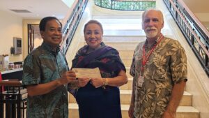 People pose with donation check